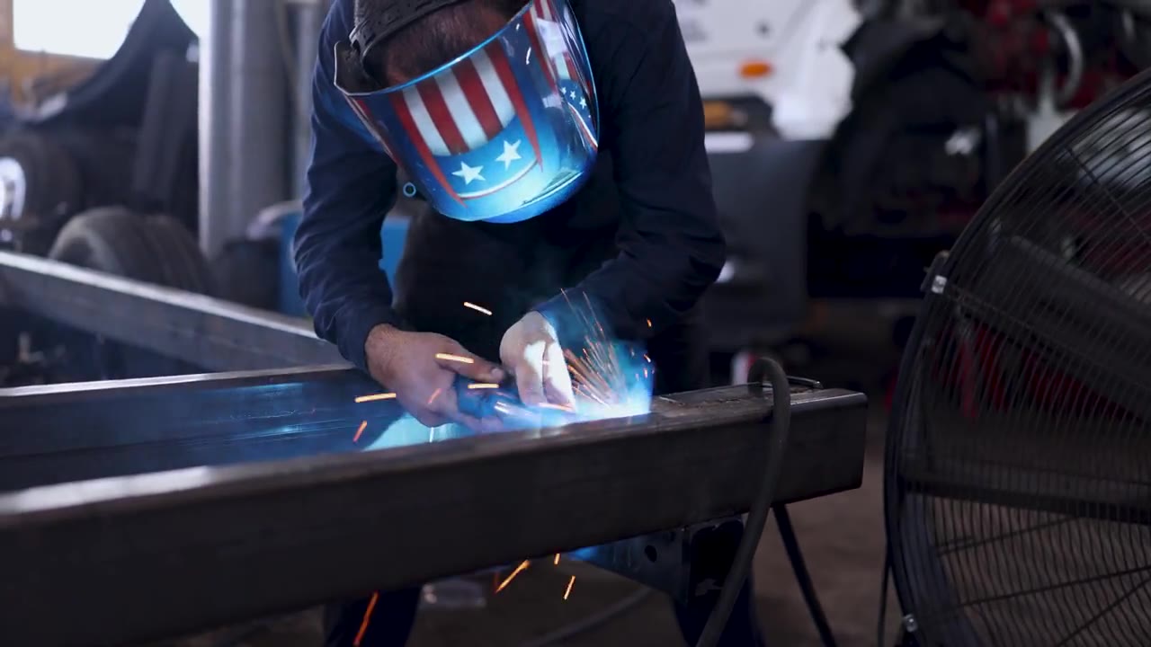 Welder at work on a factory floor